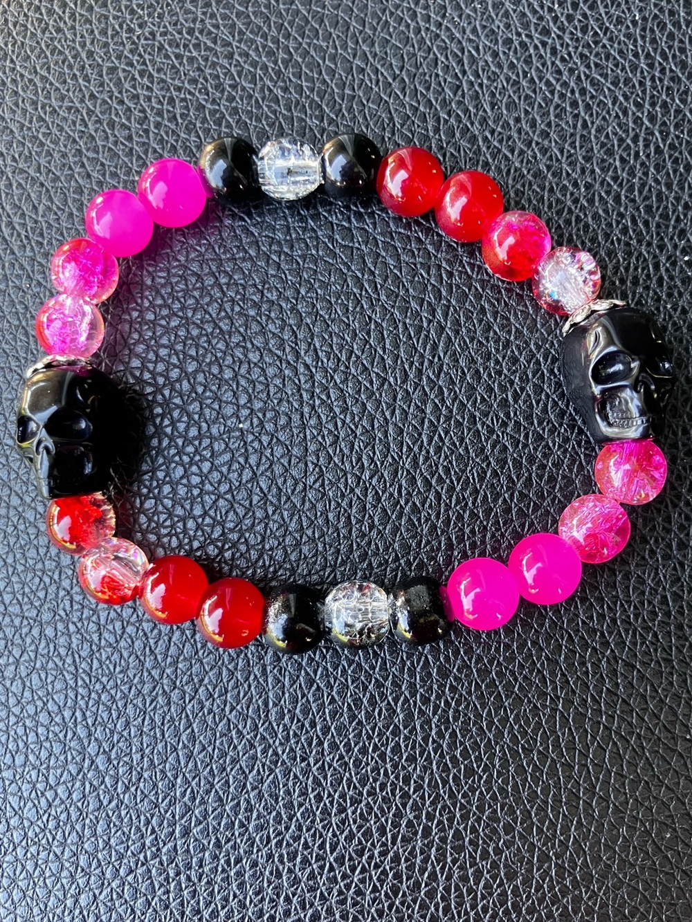 Pink, black and red glass beaded bracelet with skull accent beads